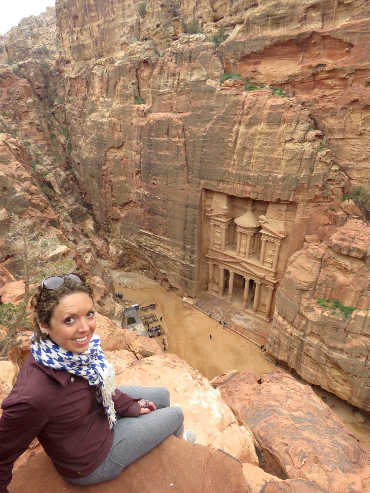 Sitting on a cliff overlooking Petra's Treasury - the best view in Jordan - by Anika Mikkelson - Miss Maps - www.MissMaps.com