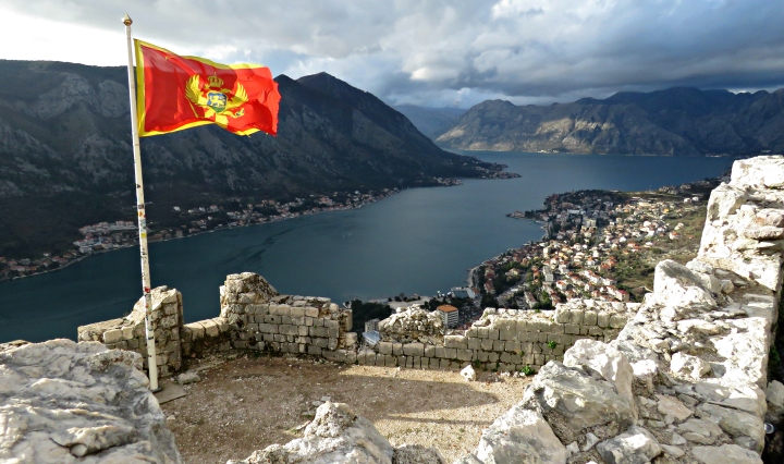 Albania's Flag from the top of Kotor Fortress - Kotor Montenegro - by Anika Mikkelson - Miss Maps - www.MissMaps.com